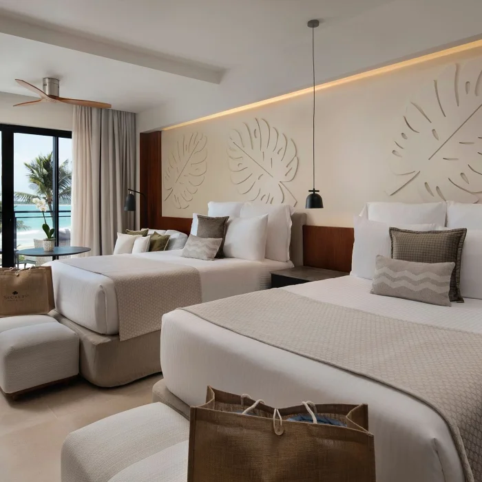 A preferred club junior suite with two beds and a balcony offering a beautiful oceanfront view.