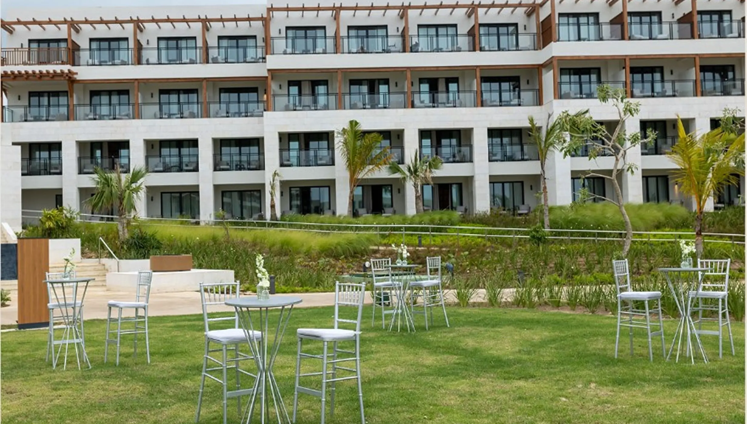 Cocktail tables on the lawn for a wedding reception at Secrets Playa Esmeralda, Miches