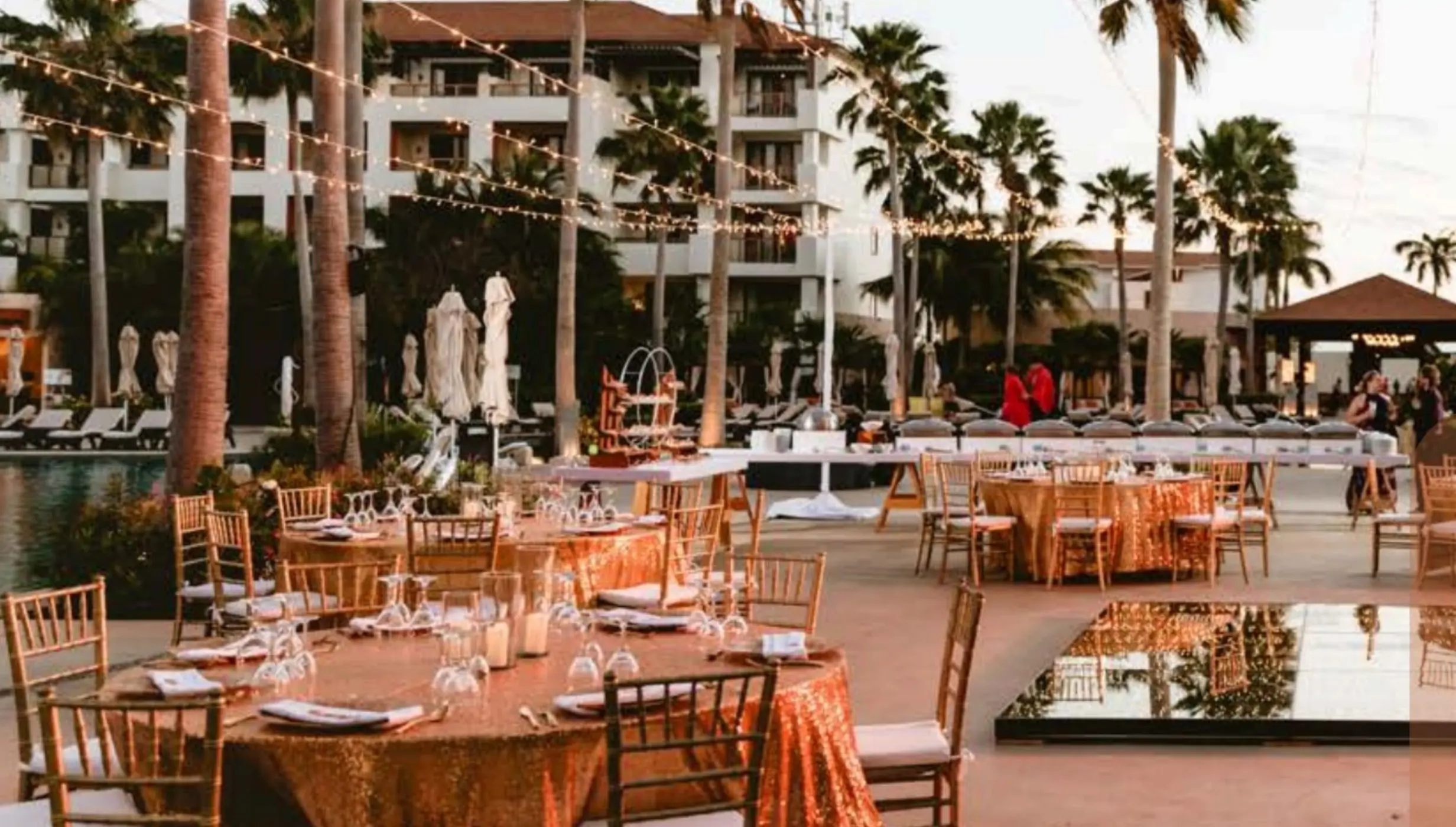 Sugar Reef Terrace wedding reception with string lights and gold décor at Secrets Playa Mujeres, Cancun