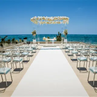Rooftop terrace wedding ceremony setup with ocean views at Secrets Riviera Cancun, Riviera Maya