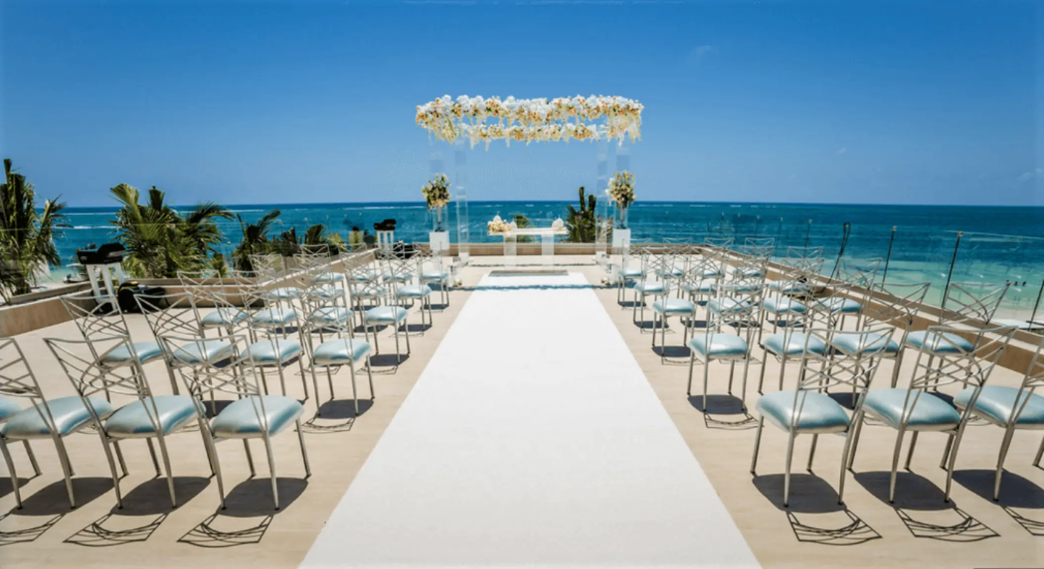 Rooftop terrace wedding ceremony setup with ocean views at Secrets Riviera Cancun, Riviera Maya