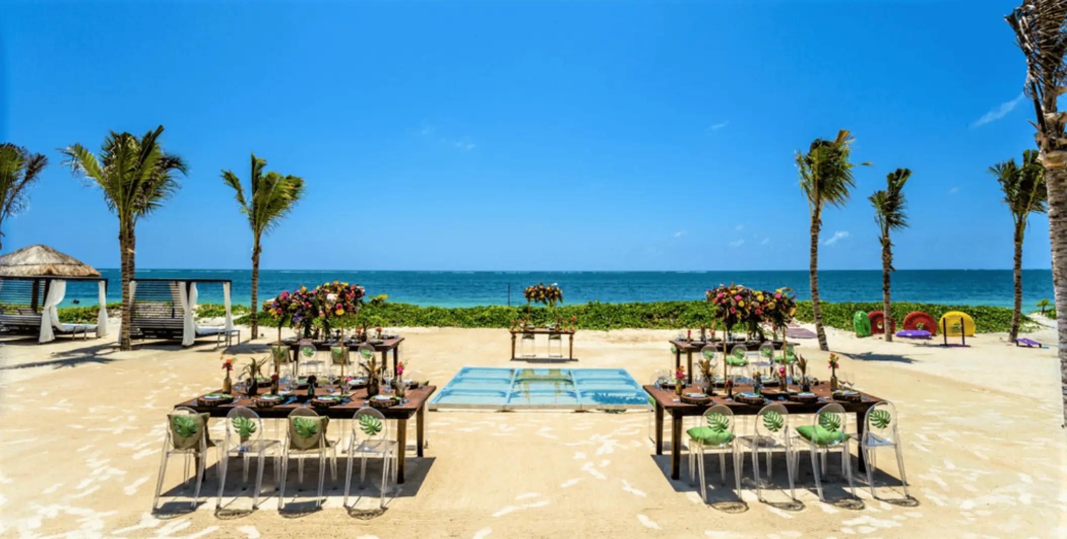 Beachfront wedding reception with acrylic chairs and dance floor at Secrets Riviera Cancun, Riviera Maya