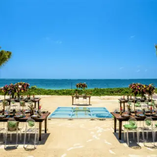 Beachfront wedding reception with acrylic chairs and dance floor at Secrets Riviera Cancun, Riviera Maya