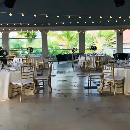 Eclipse Nightclub wedding reception setup with gold chairs and string lights at Secrets Royal Beach, Punta Cana