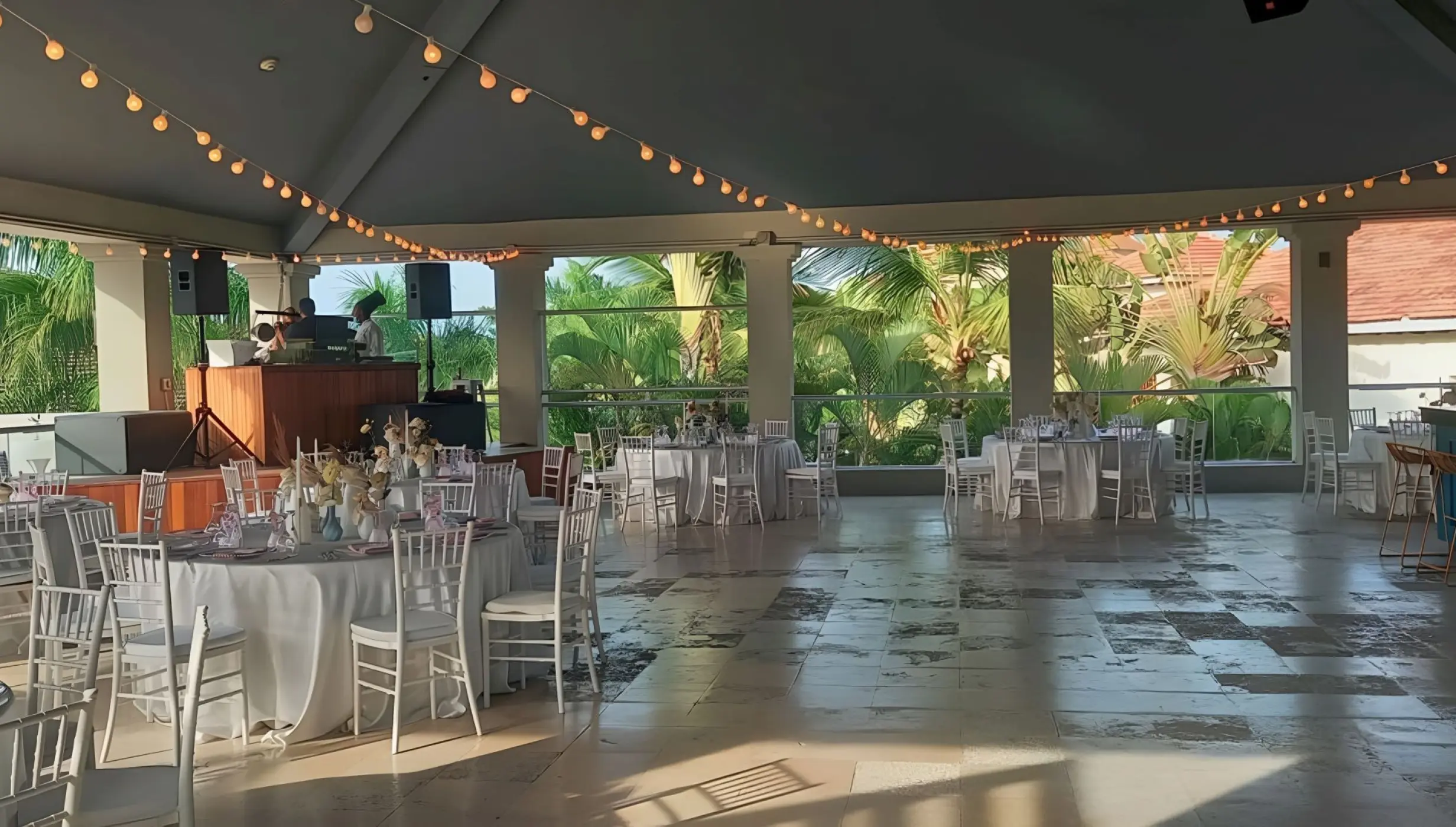 Eclipse Nightclub wedding reception setup with white tables and string lights at Secrets Royal Beach, Punta Cana