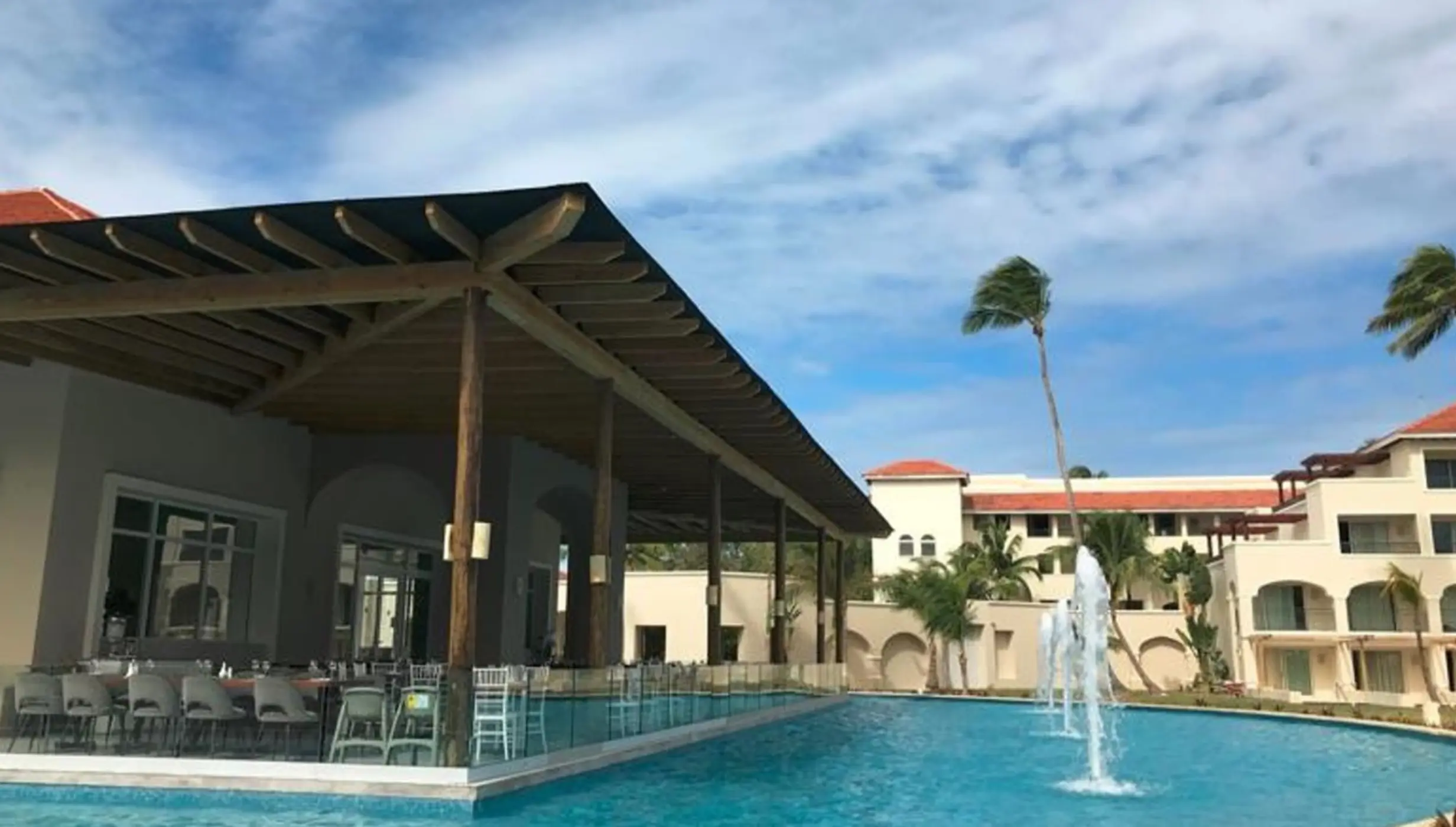 Riviera Terrace overlooking the pool with fountains at Secrets Royal Beach, Punta Cana