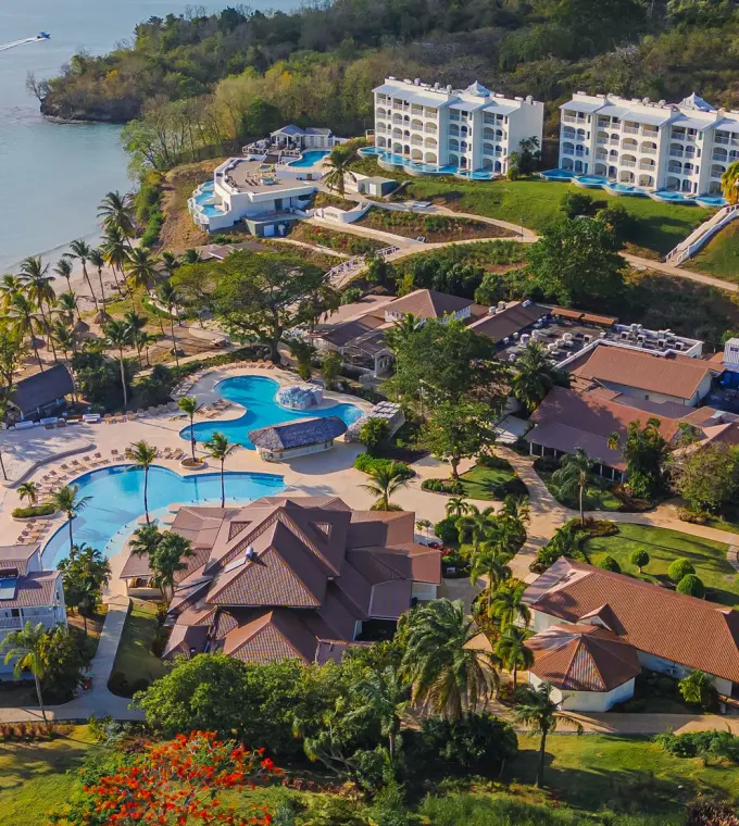 Aerial view of Secrets St. Lucia buildings and swimming pools along the beach, Castries
