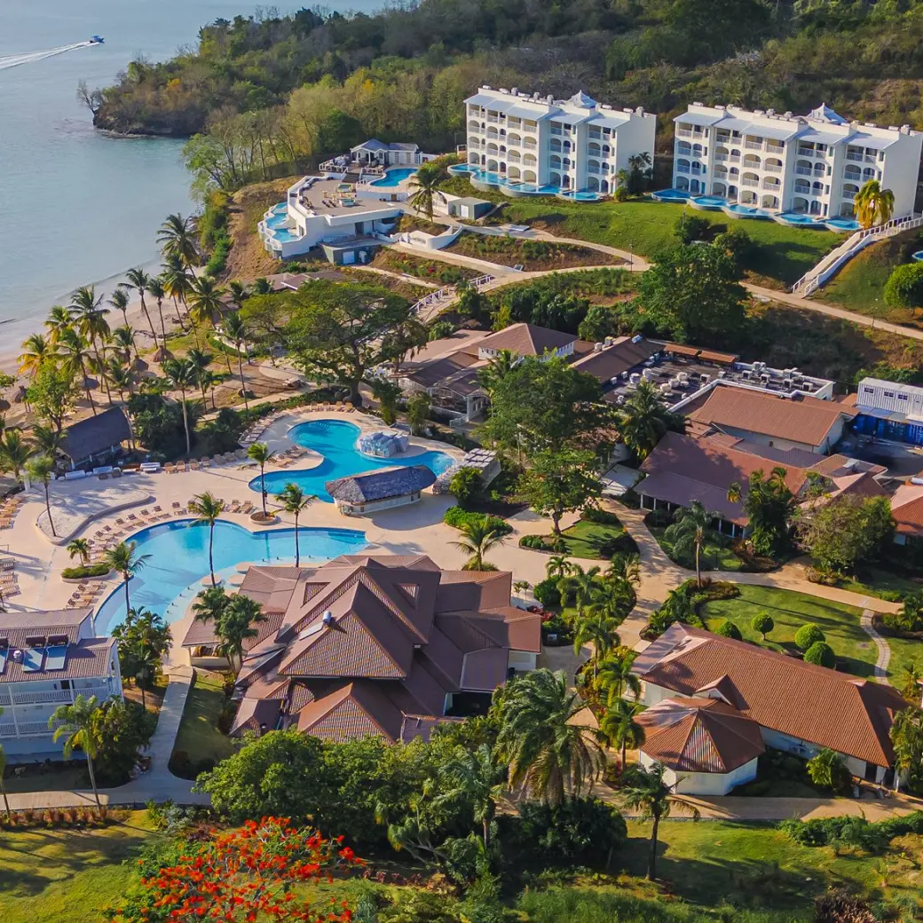 Aerial view of Secrets St. Lucia buildings and swimming pools along the beach, Castries