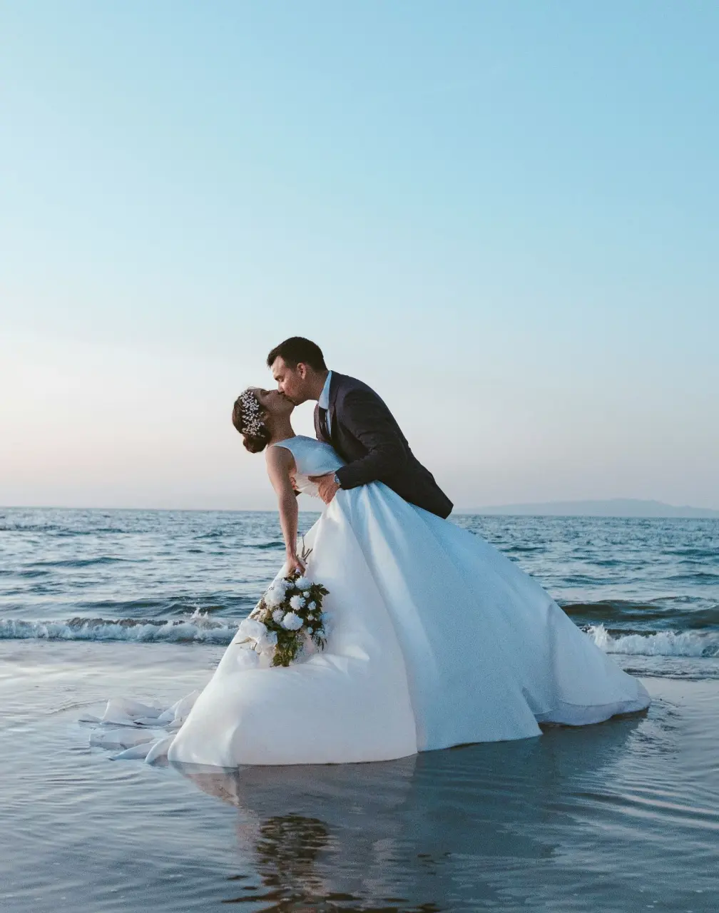 Bride and groom kissing on the beach at Secrets St. Lucia