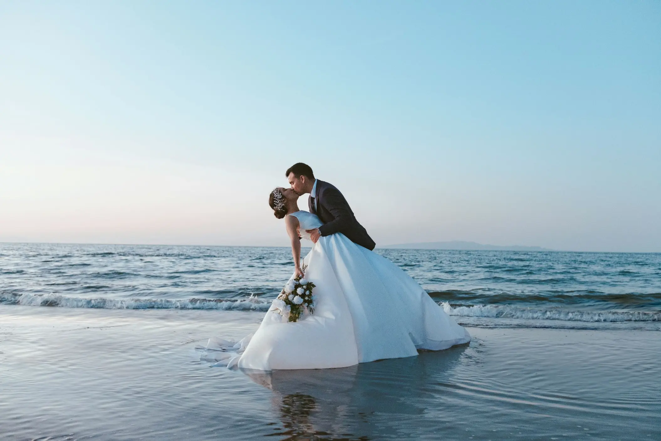 Bride and groom kissing on the beach at Secrets St. Lucia