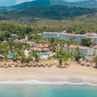 aerial view of the beach and resort buildings and pools of Secrets St Lucia