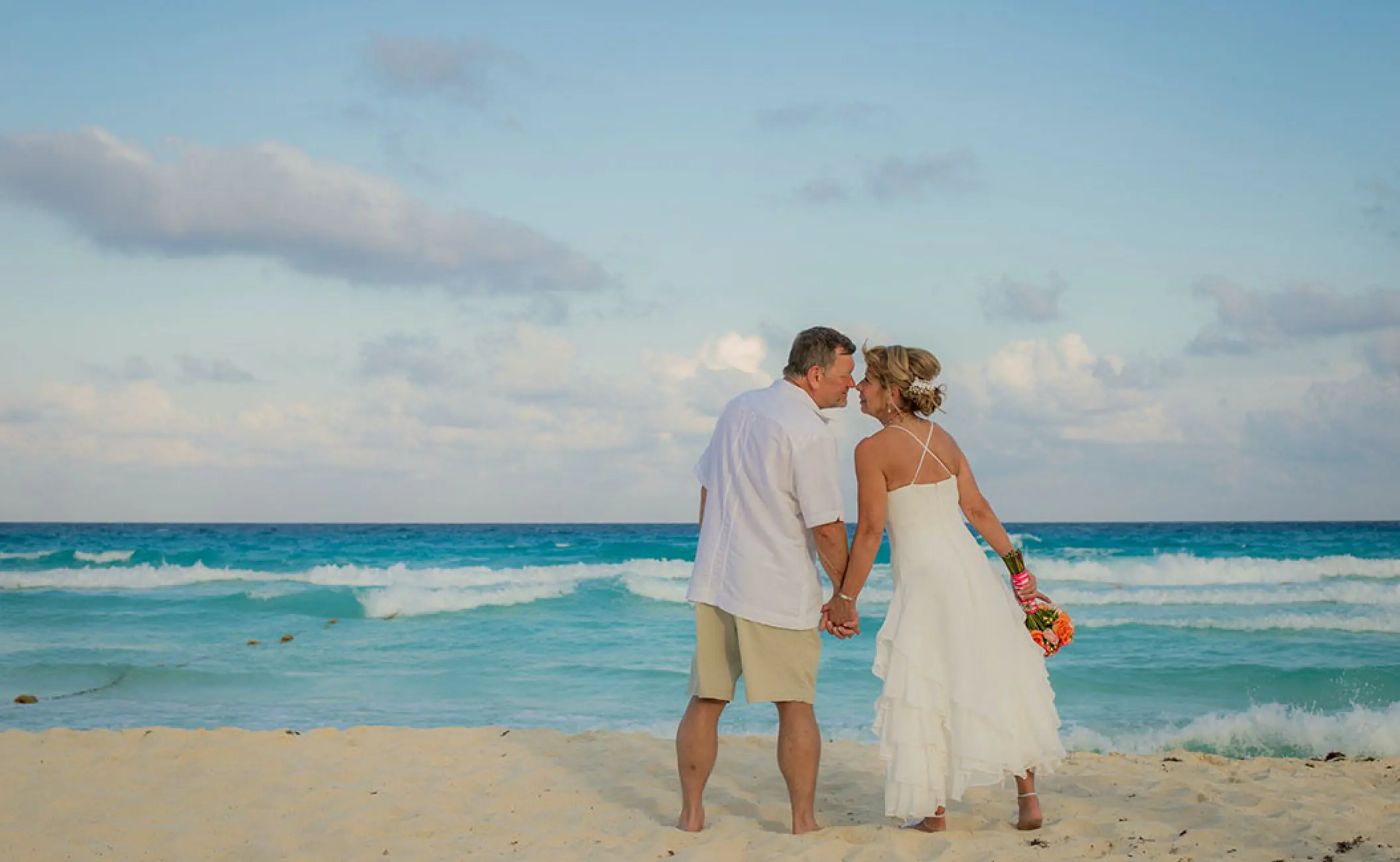 Bride and groom standing on the beach at Secrets The Vine, Cancun