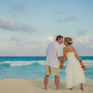 Bride and groom standing on the beach at Secrets The Vine, Cancun
