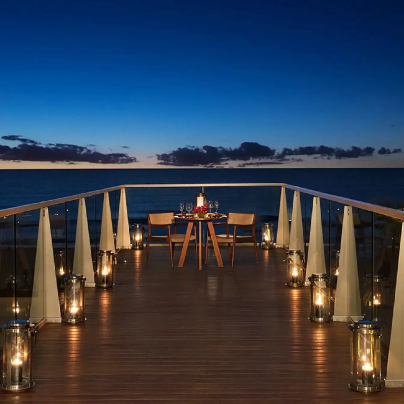Private romantic dinner setup on a terrace at sunset, Secrets The Vine, Cancun