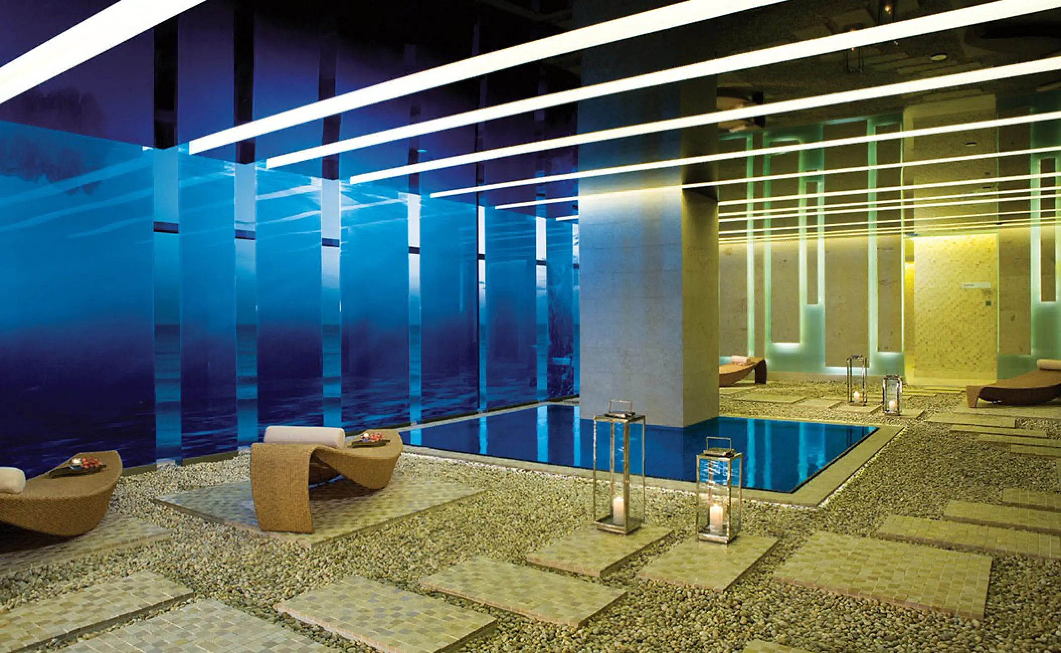 Indoor spa pool and relaxation lounge with lantern lighting at Secrets The Vine, Cancun