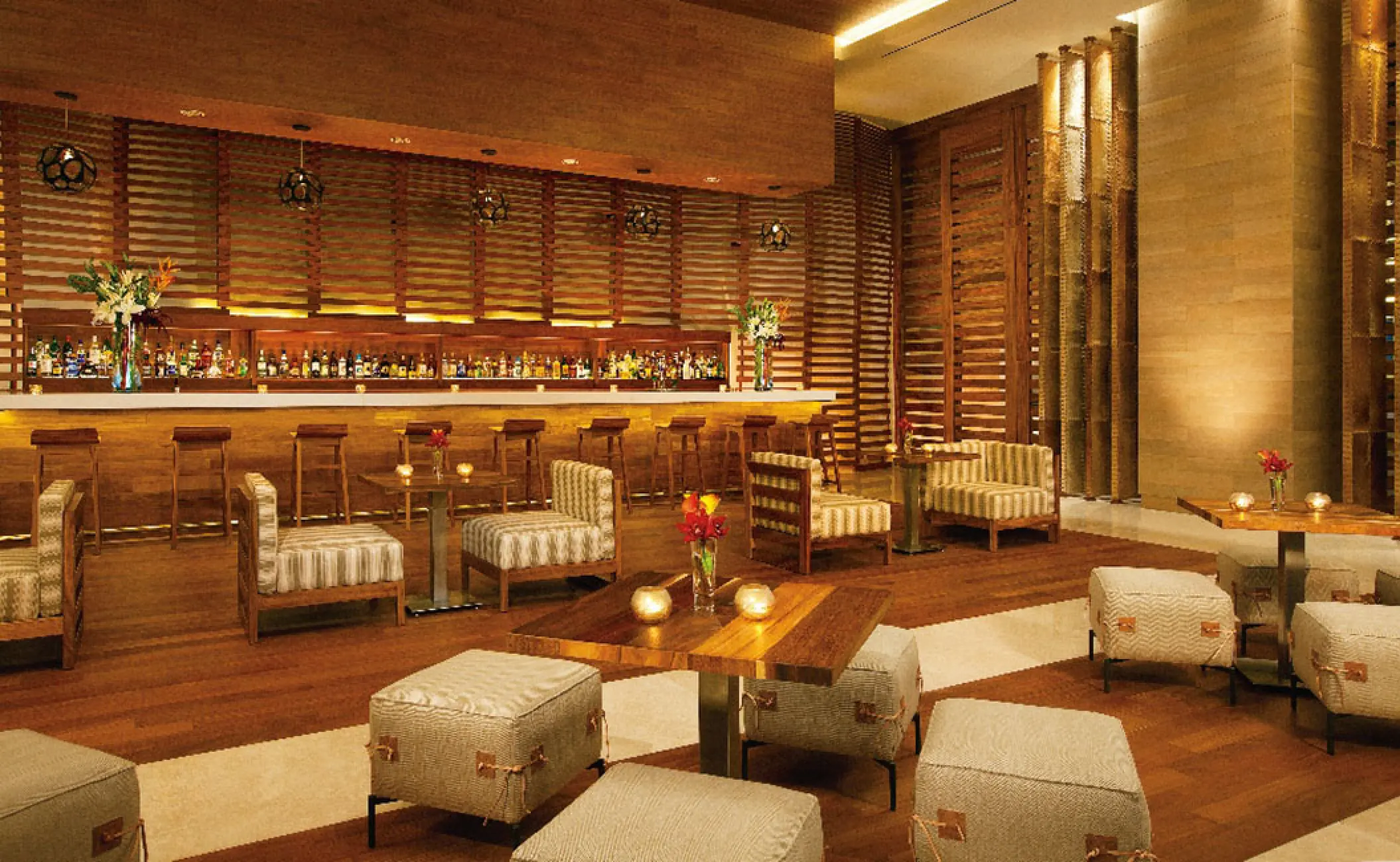 Modern lobby bar with wood paneling and lounge seating at Secrets The Vine, Cancun