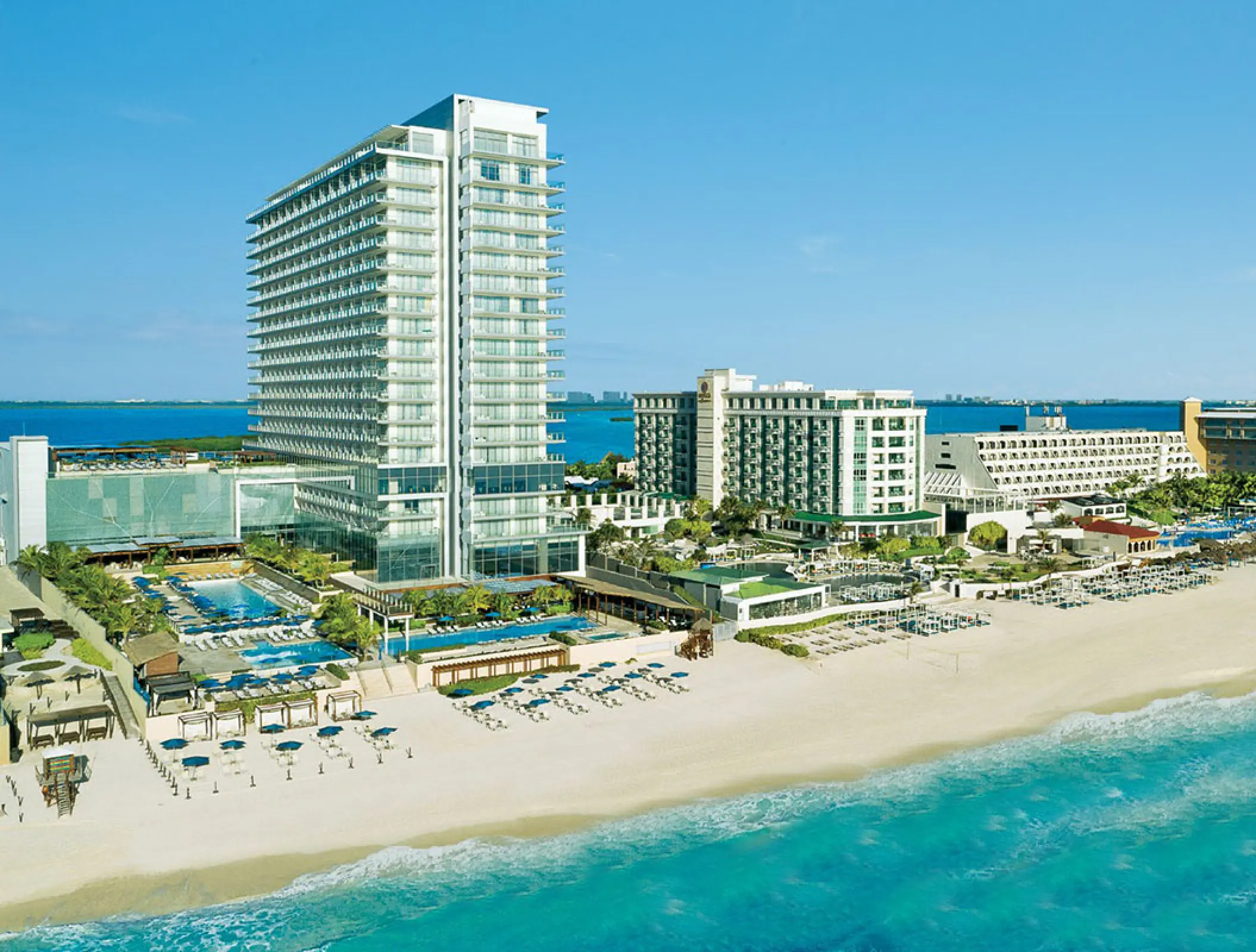 Aerial view of Secrets The Vine Cancun beachfront high-rise and pools, Cancun