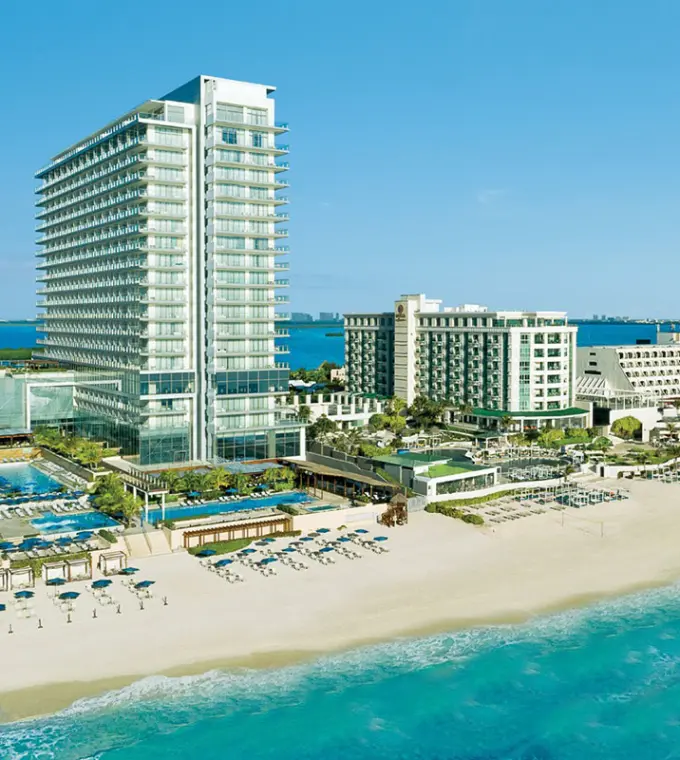 Aerial view of Secrets The Vine Cancun beachfront high-rise and pools, Cancun