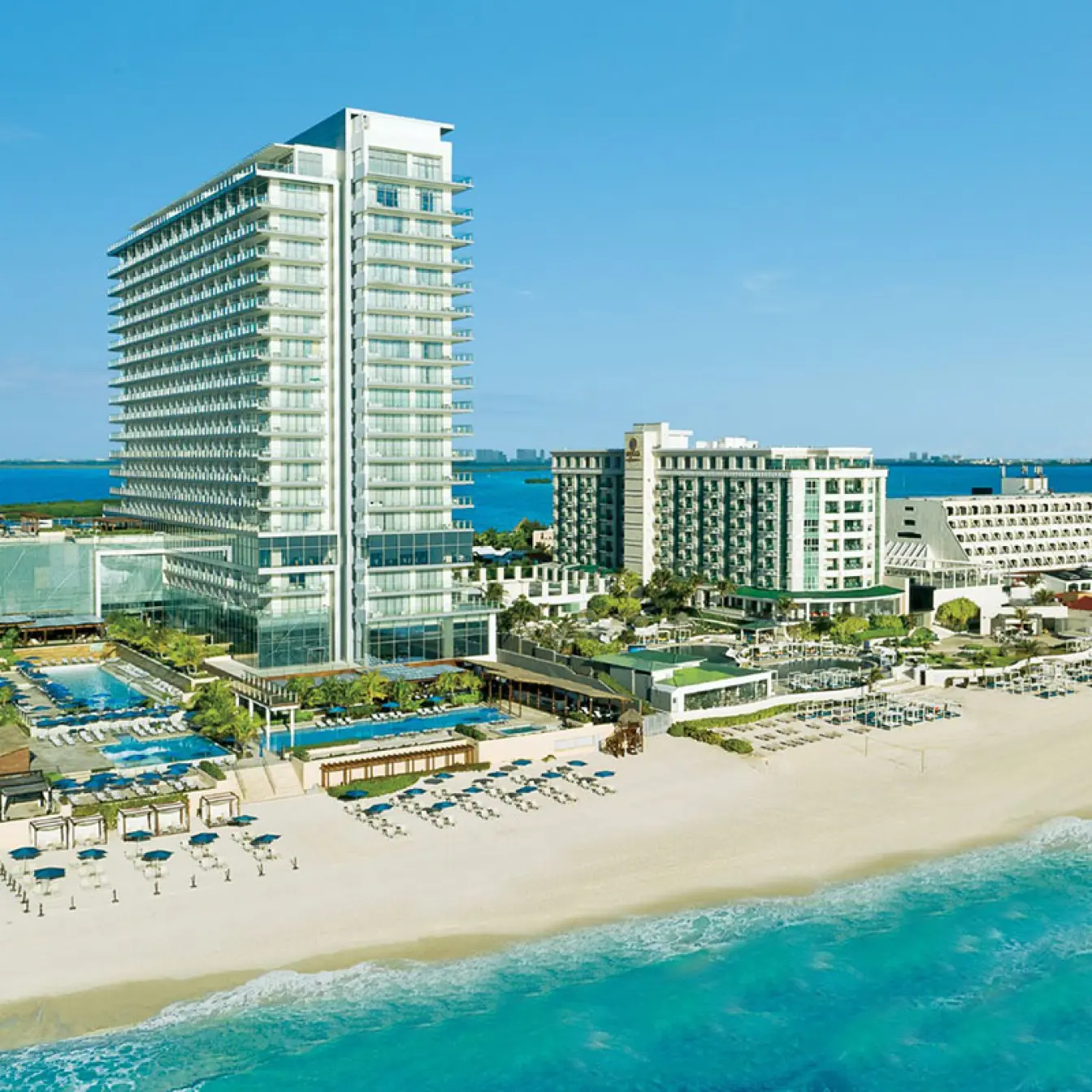 Aerial view of Secrets The Vine Cancun beachfront high-rise and pools, Cancun