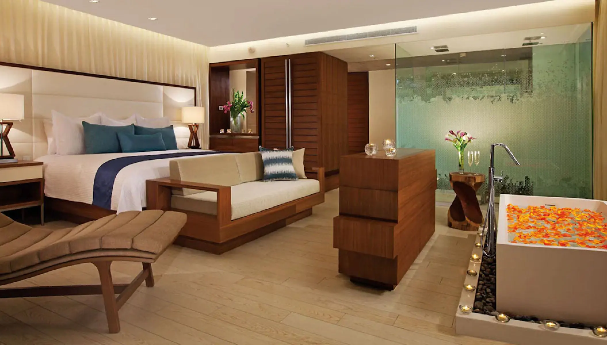 Honeymoon suite with a king bed and flower-filled soaking tub at Secrets The Vine, Cancun