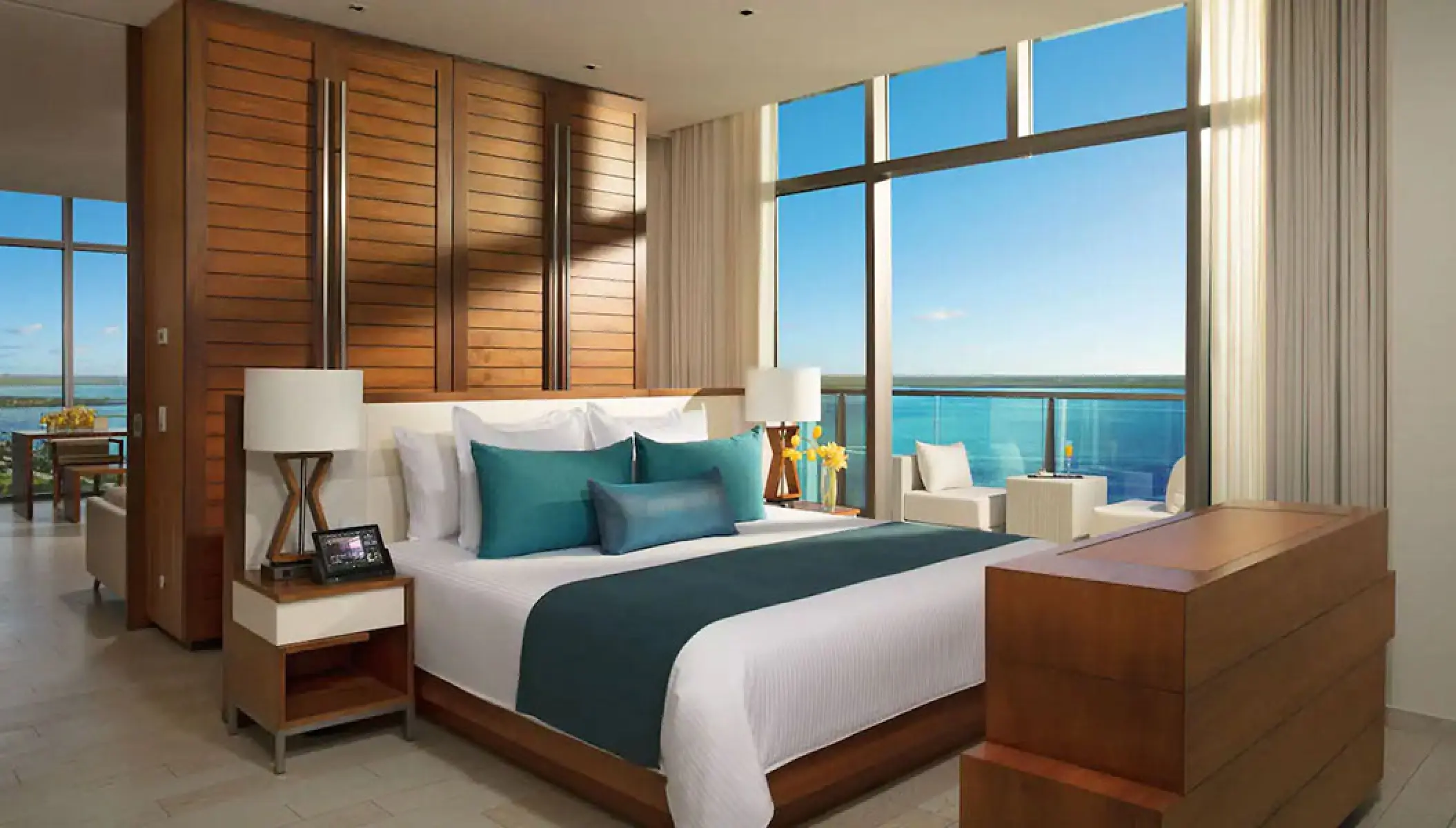 Master suite with teal accents and a private balcony overlooking the ocean at Secrets The Vine, Cancun