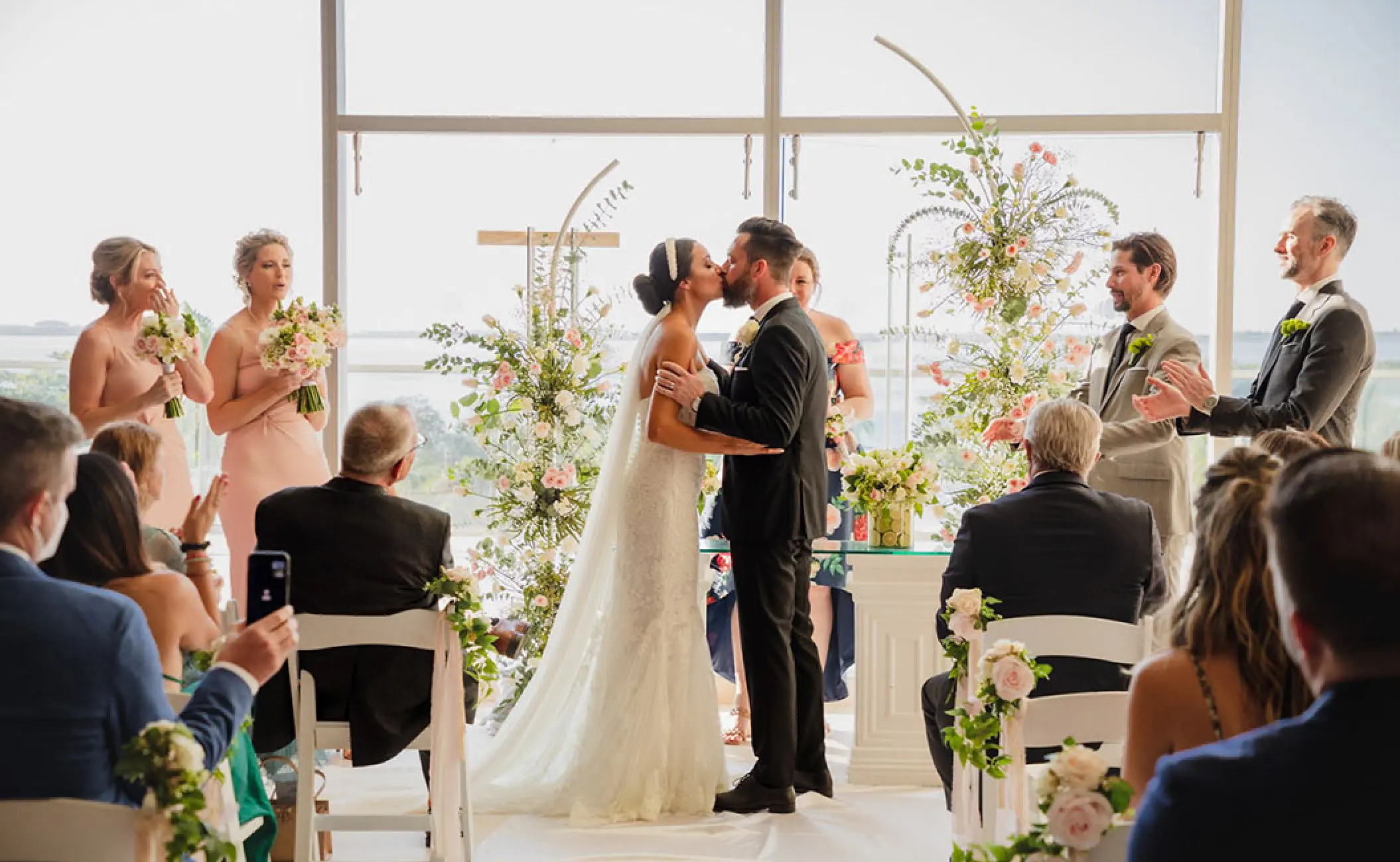 Bride and groom kissing during their wedding ceremony at Secrets The Vine, Cancun
