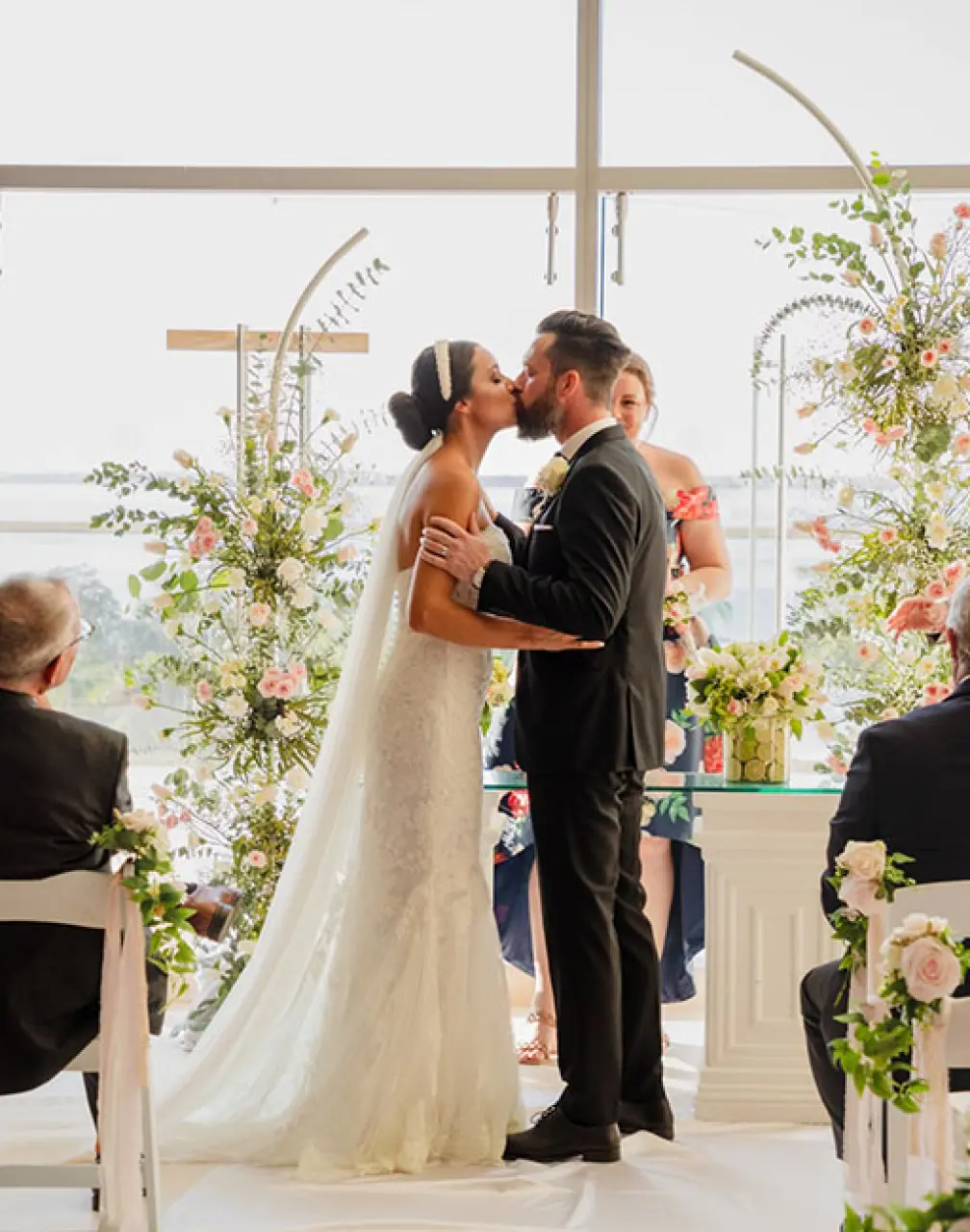 Bride and groom kissing during their wedding ceremony at Secrets The Vine, Cancun
