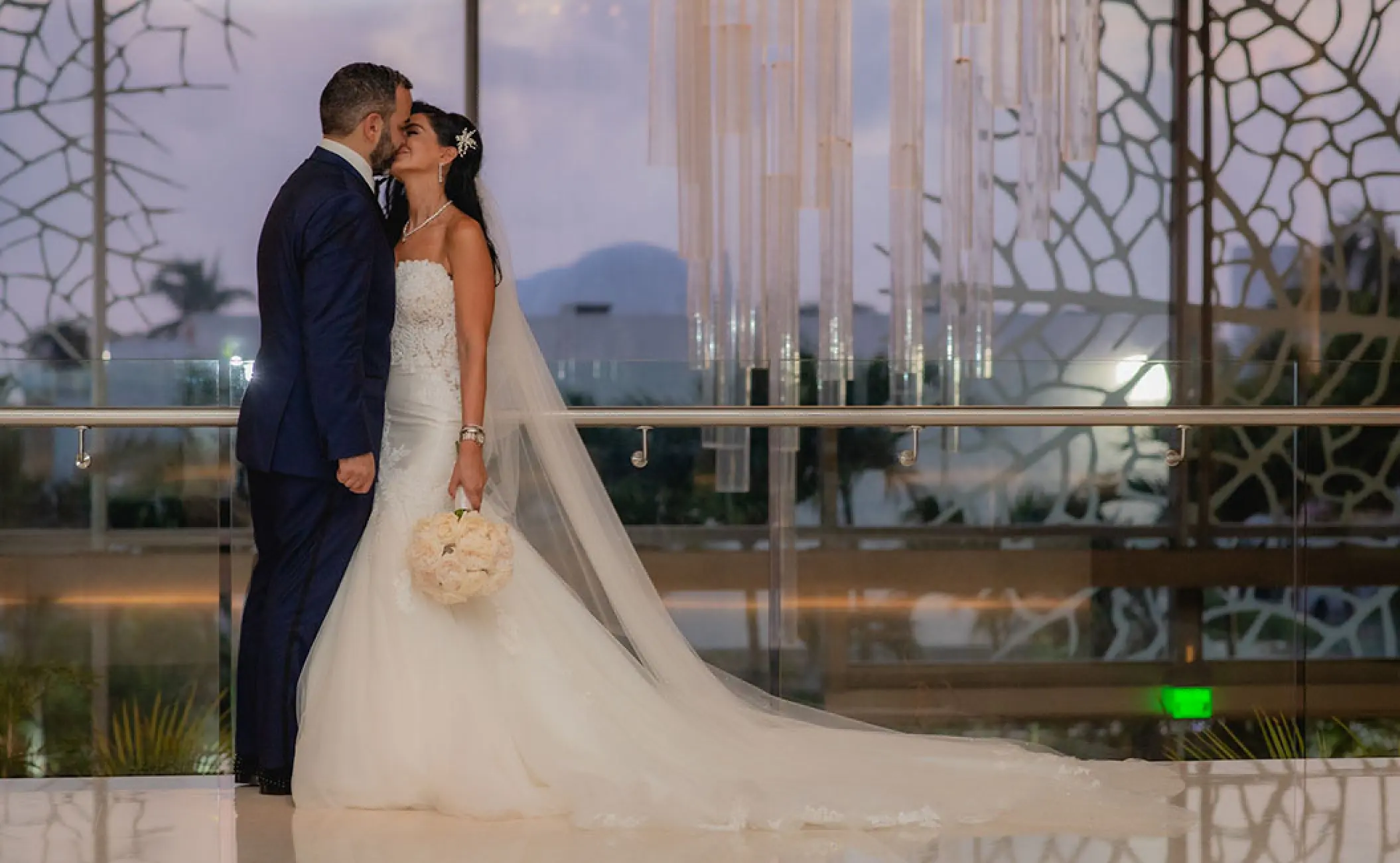 Bride and groom kissing indoors at Secrets The Vine Cancun