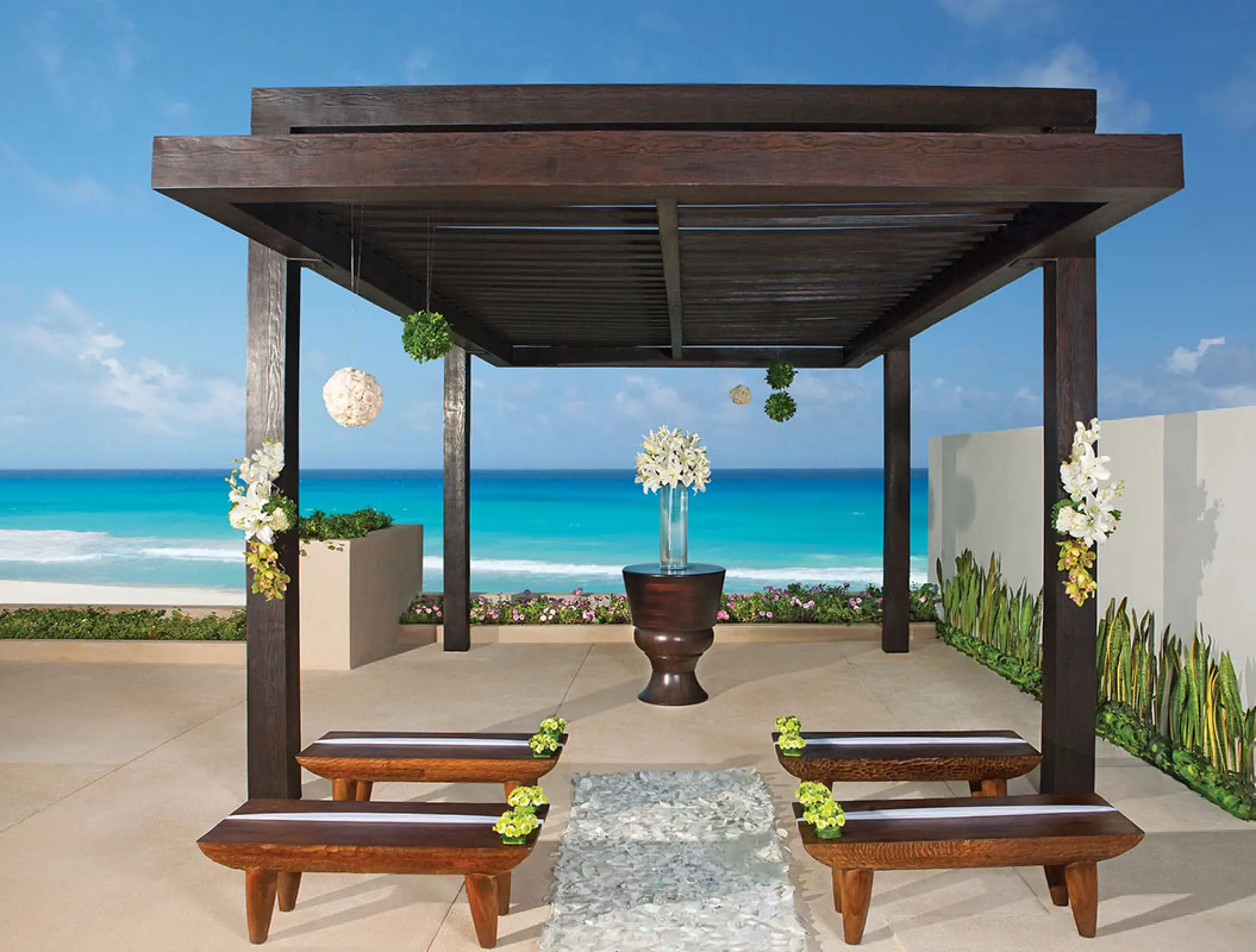 Terrace wedding ceremony gazebo with ocean views at Secrets The Vine, Cancun