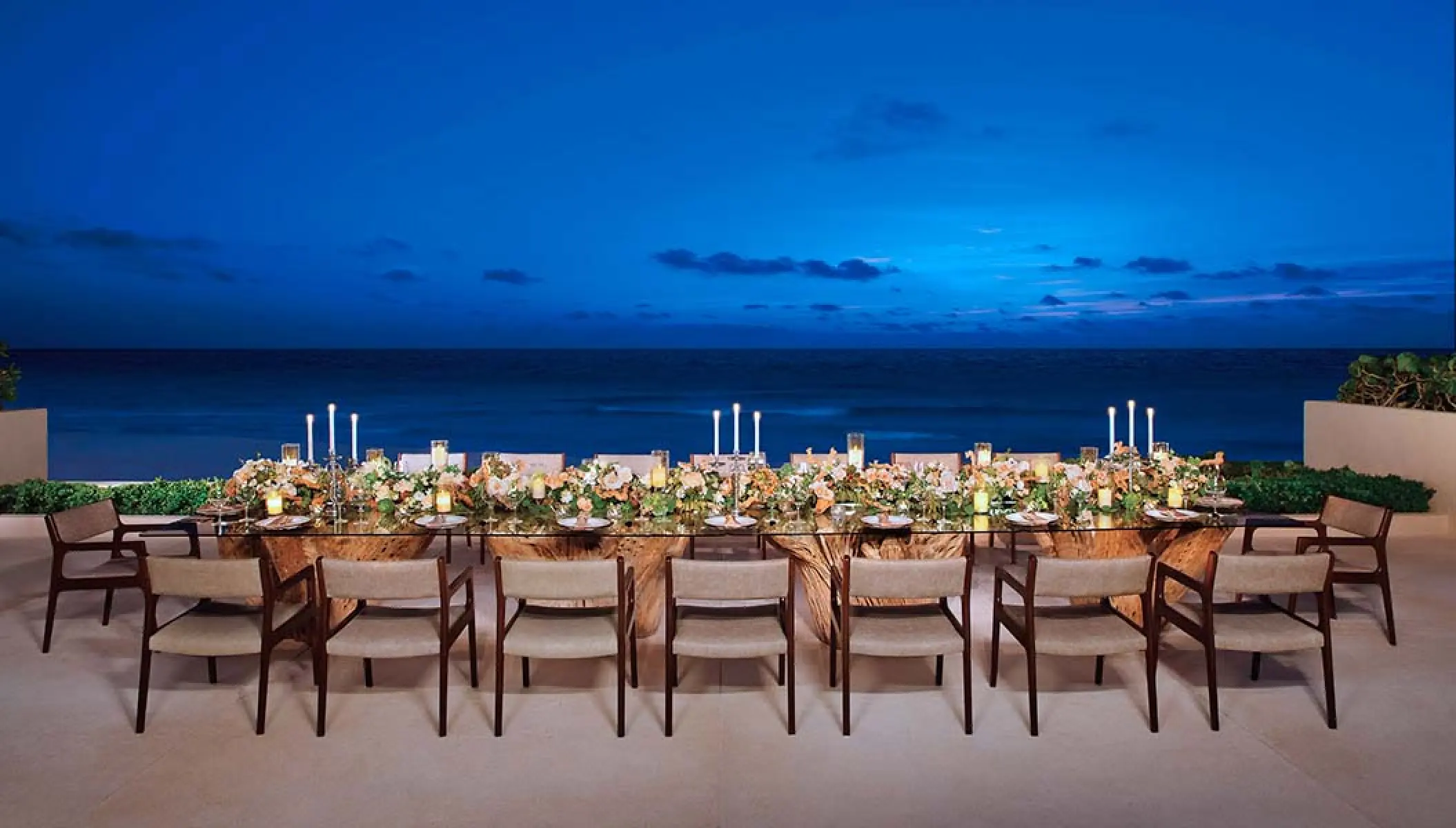 Outdoor wedding reception dinner set on a terrace at Secrets The Vine, Cancun