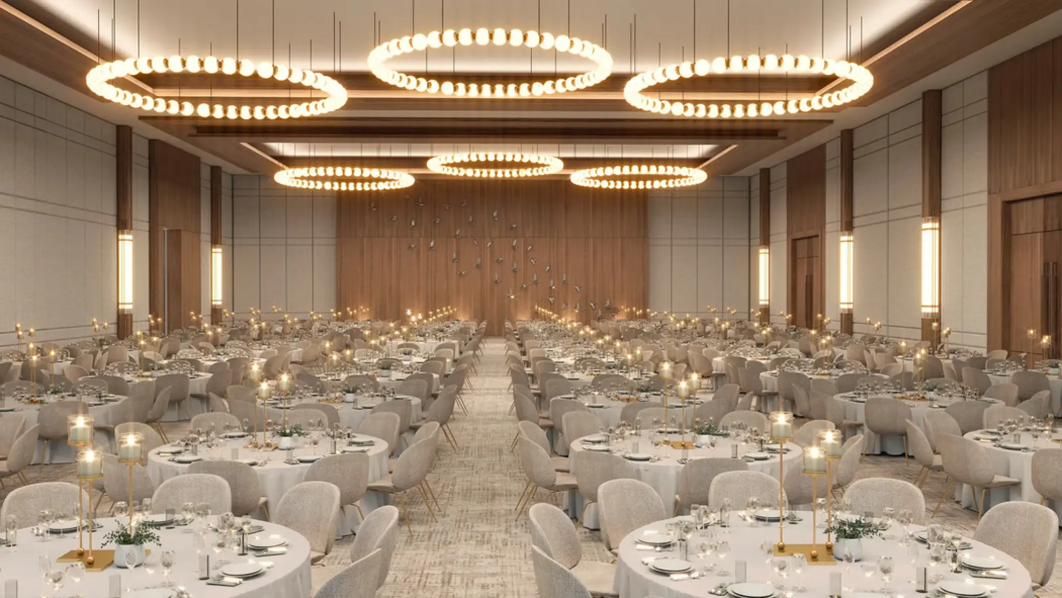 Ballroom wedding reception setup with circular chandeliers and round tables at Secrets Tides, Punta Cana