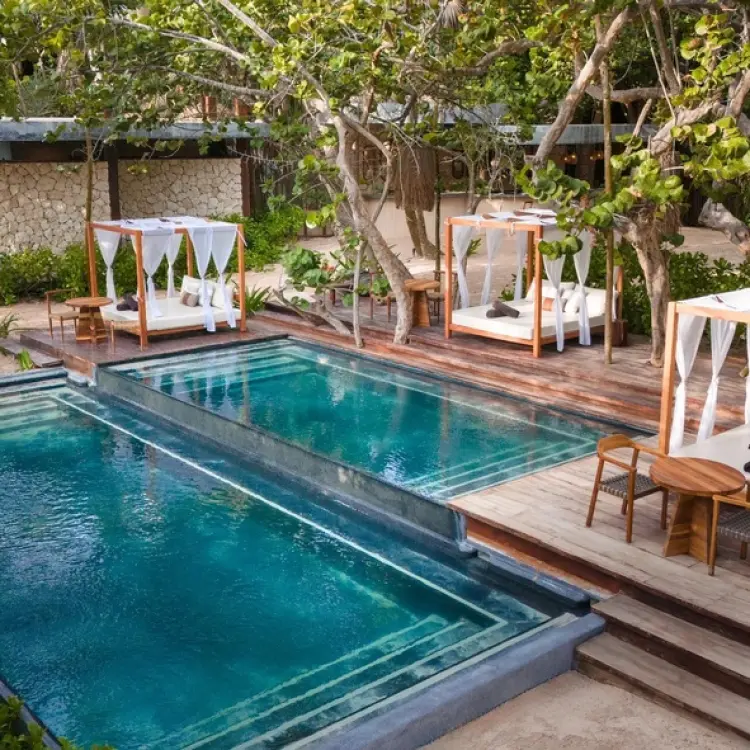 Secrets Tulum beach club pools and cabanas surrounded by lush greenery, Tulum