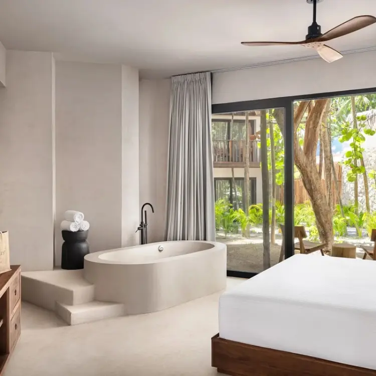 Casa Zamna suite with soaking tub and tropical garden views at Secrets Tulum