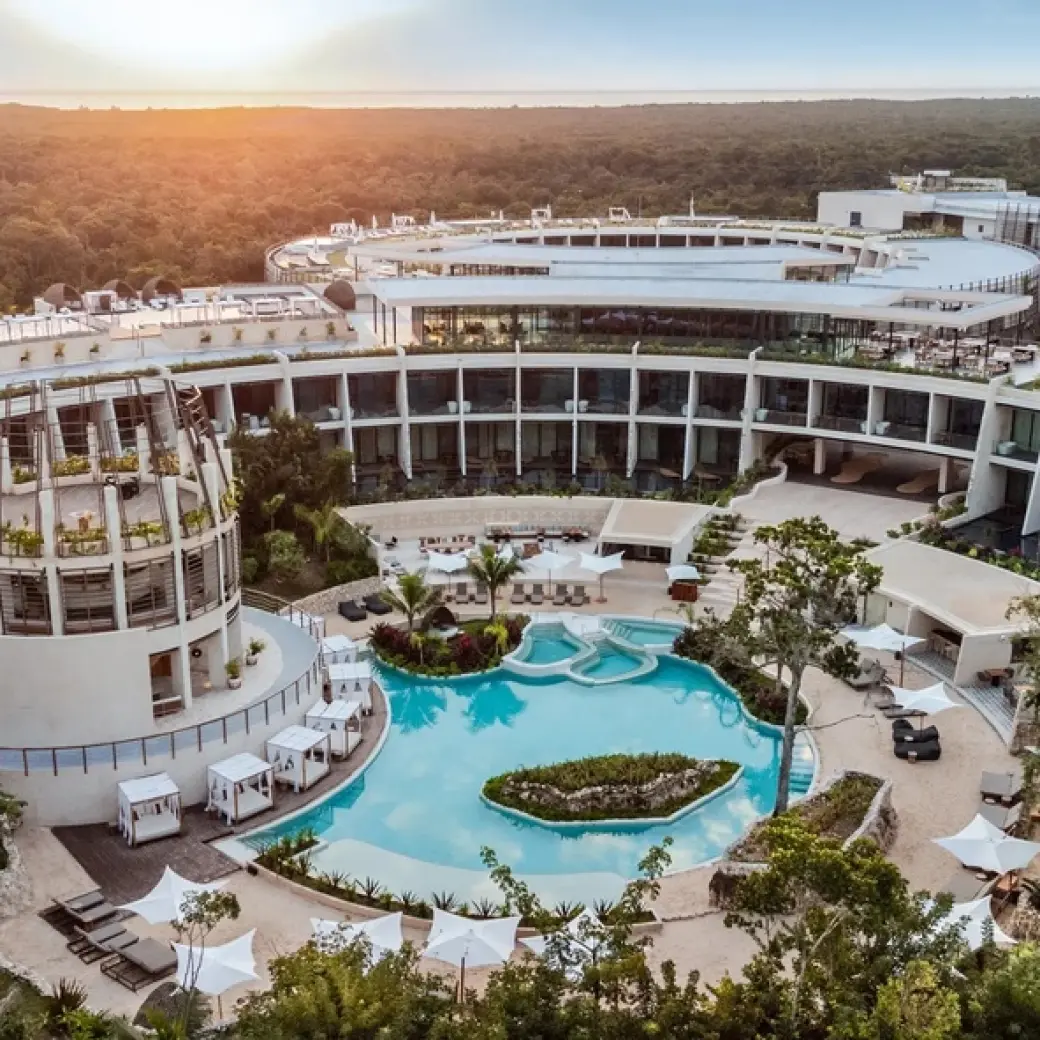 Aerial view of Secrets Tulum circular architecture and central pool at sunset, Tulum