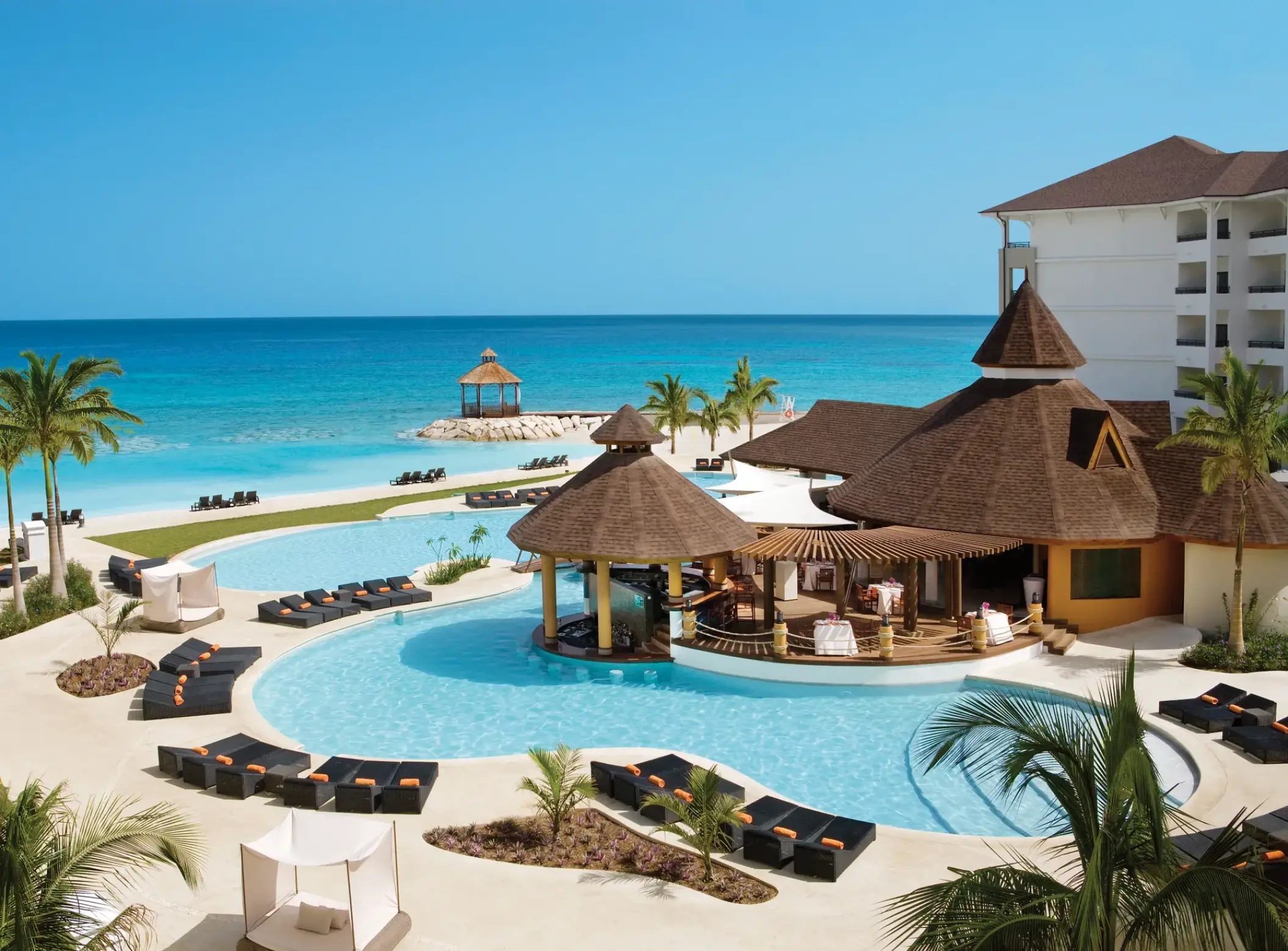 Secrets Wild Orchid Montego Bay beachfront swimming pool and thatched swim-up bar, Montego Bay