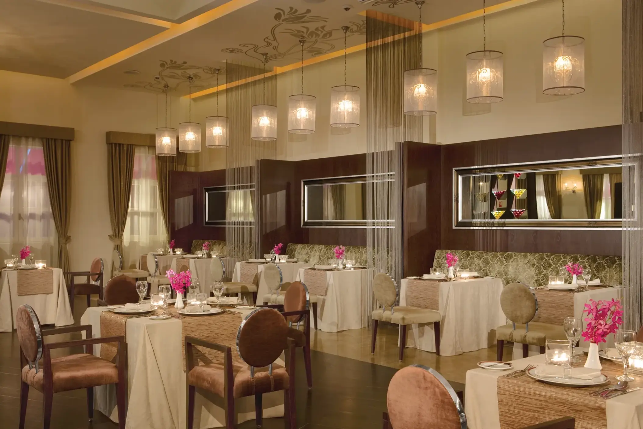 Bordeaux French restaurant dining room with elegant pendant lighting at Secrets St James, Montego Bay