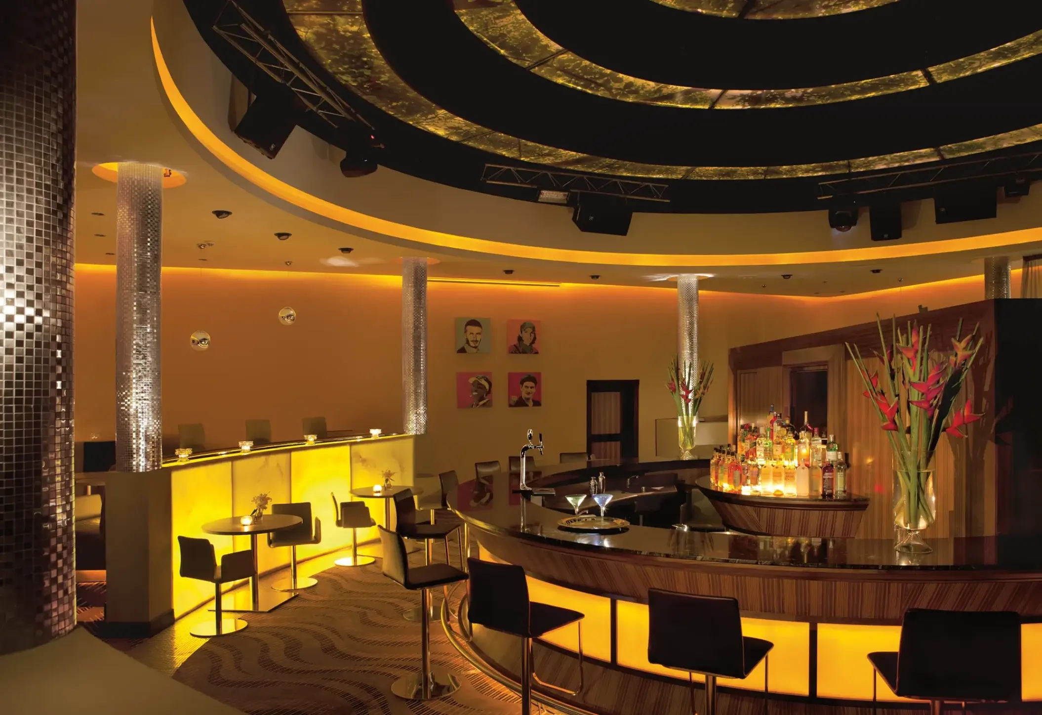 Desires Bar with circular light fixtures and lounge seating at Secrets Wild Orchid, Montego Bay