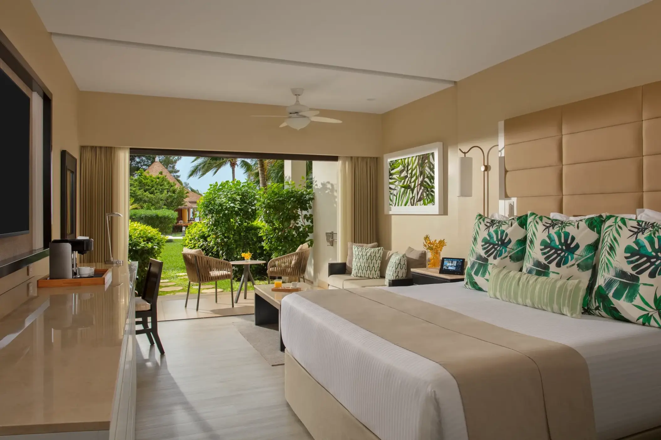 Junior Suite garden view with tropical decor at Secrets Wild Orchid, Montego Bay
