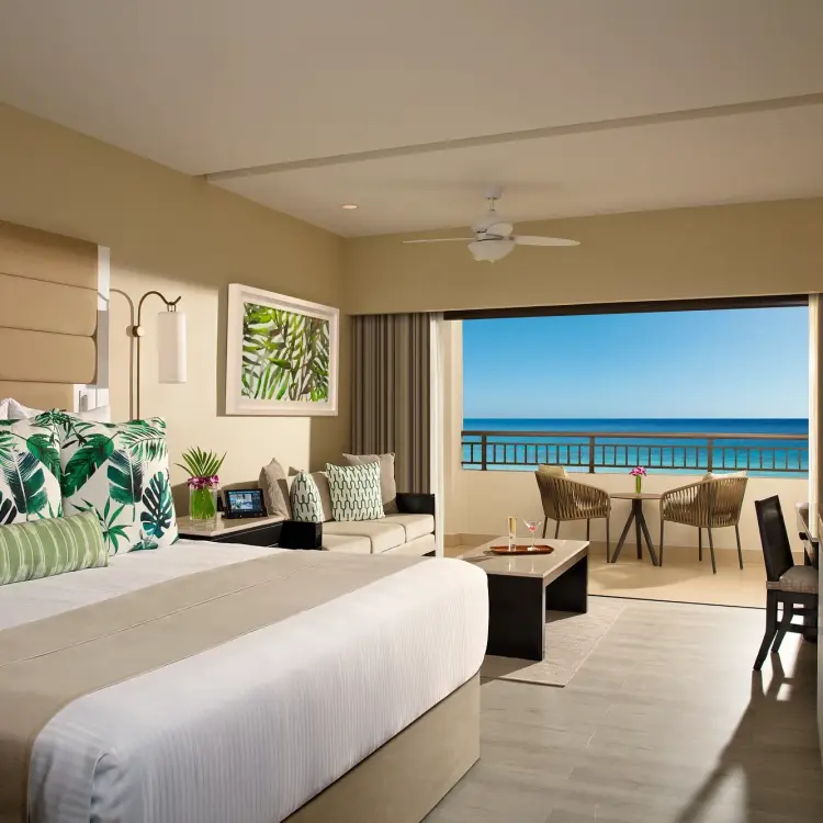 Secrets Wild Orchid junior suite bedroom opening onto an ocean view balcony, Montego Bay