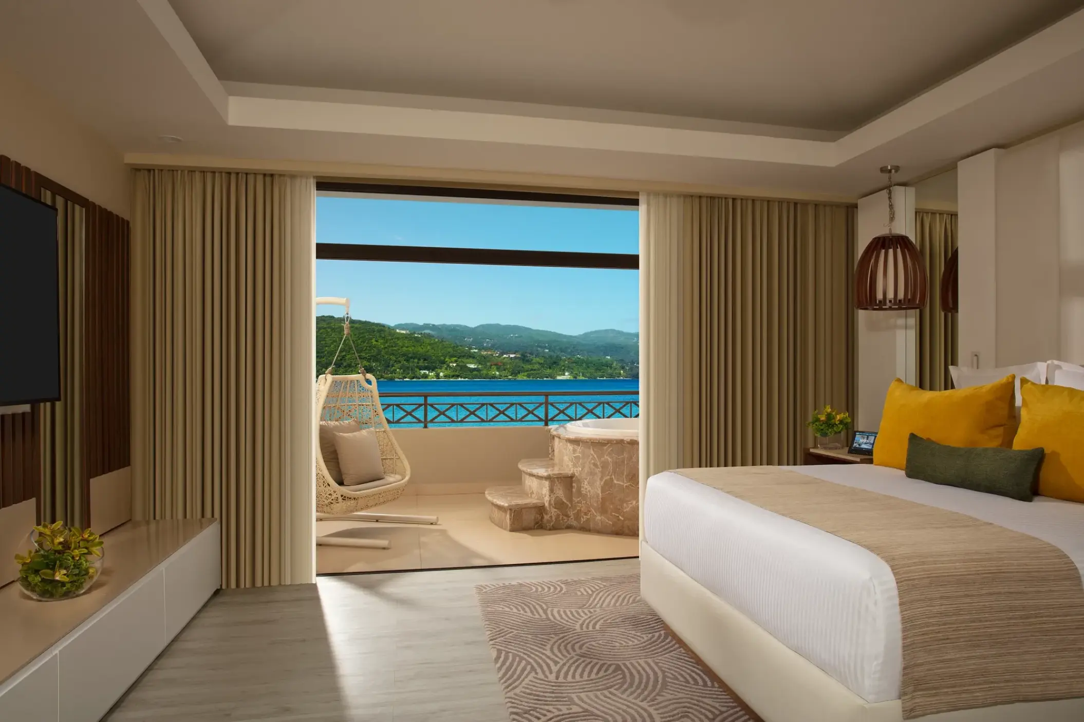 Presidential suite bedroom with oceanfront balcony at Secrets Wild Orchid, Montego Bay
