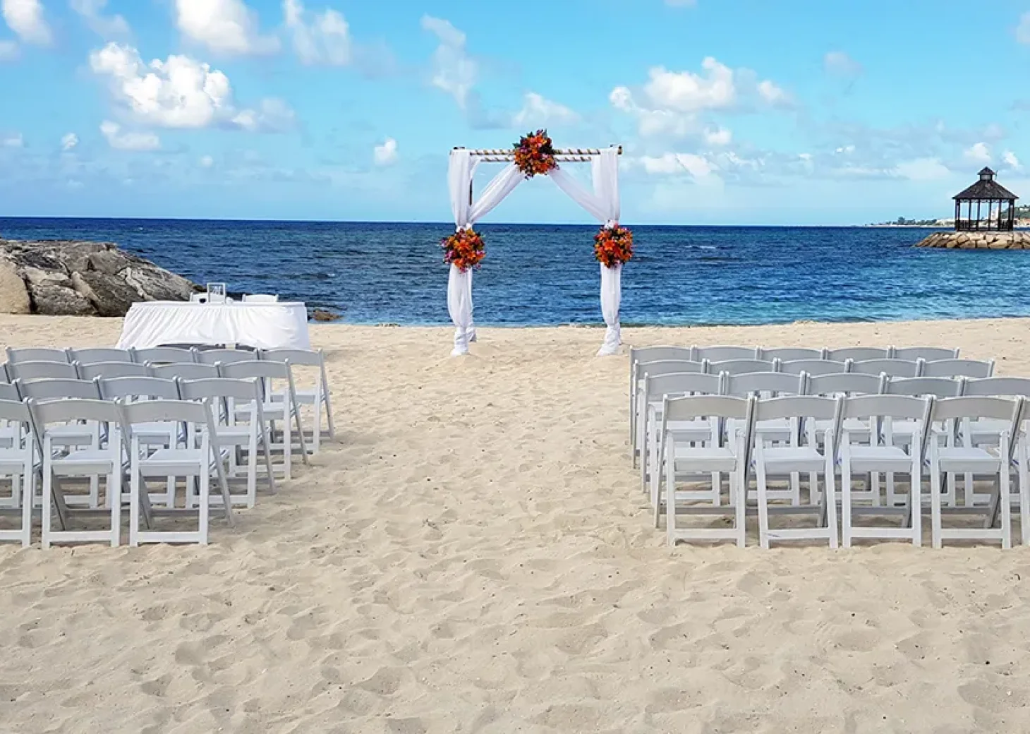 Ceremony setup on the Barracuda beach venue at Secrets Wild Orchid.