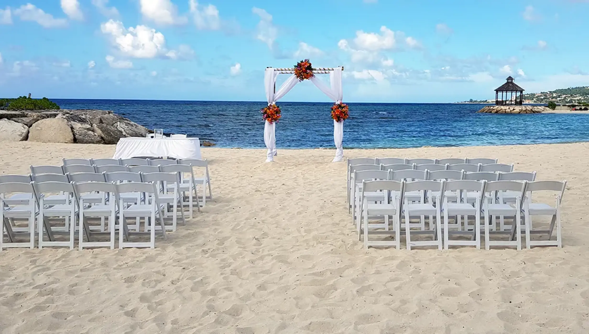 Ceremony setup on the Barracuda beach venue at Secrets Wild Orchid.