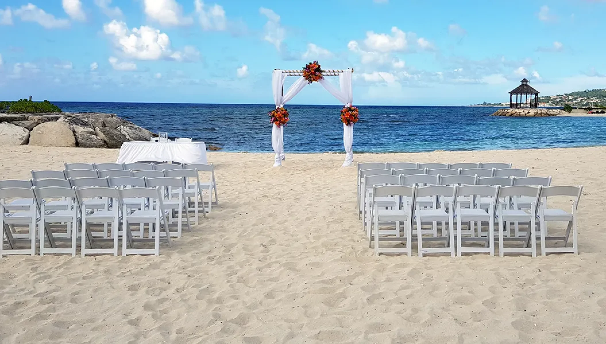 Ceremony setup on the Barracuda beach venue at Secrets Wild Orchid.