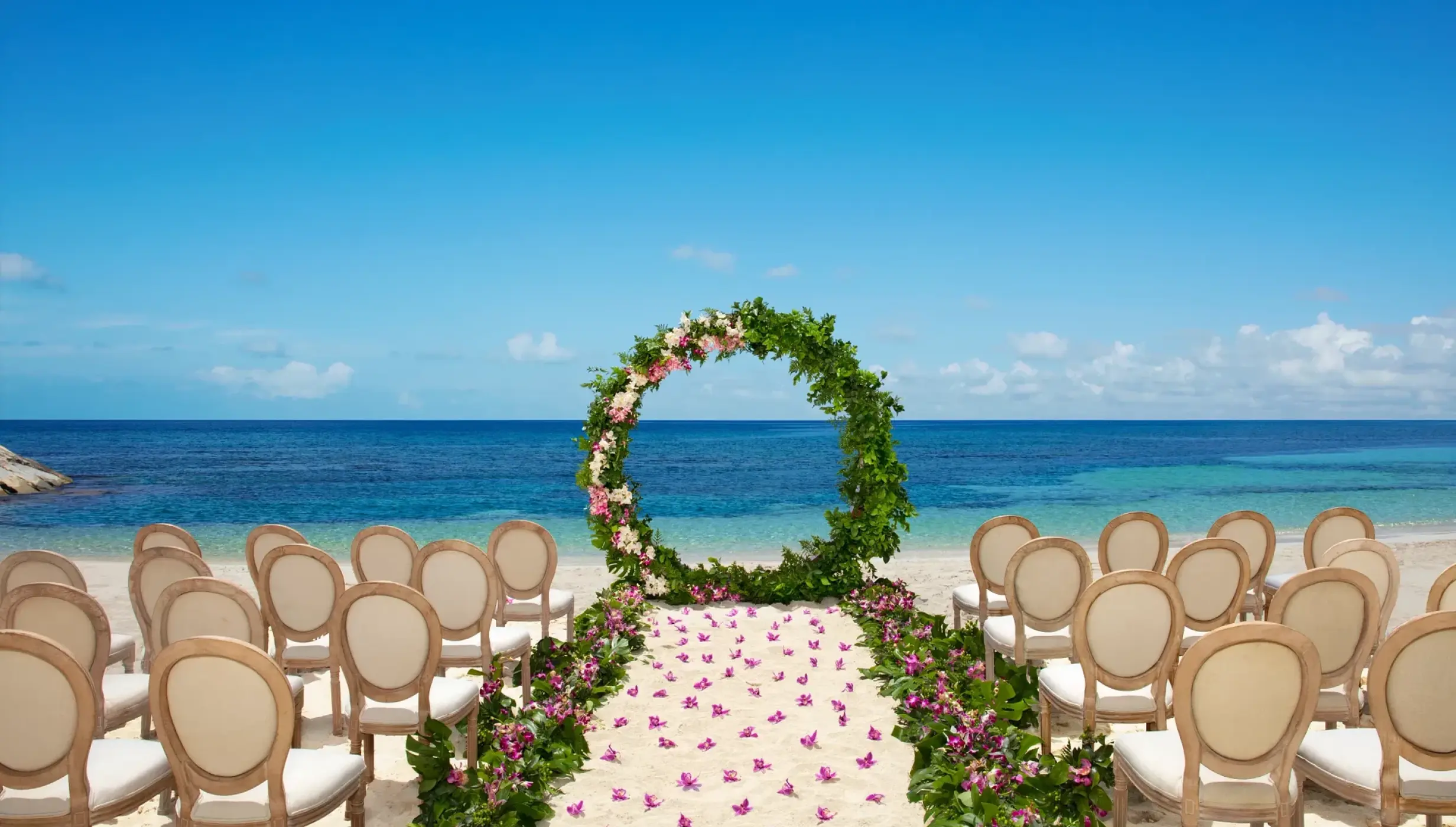 Ceremony setup on the Barracuda beach venue at Secrets Wild Orchid.