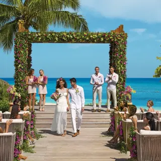 Outdoor wedding ceremony under a floral gazebo at Secrets St James, Montego Bay