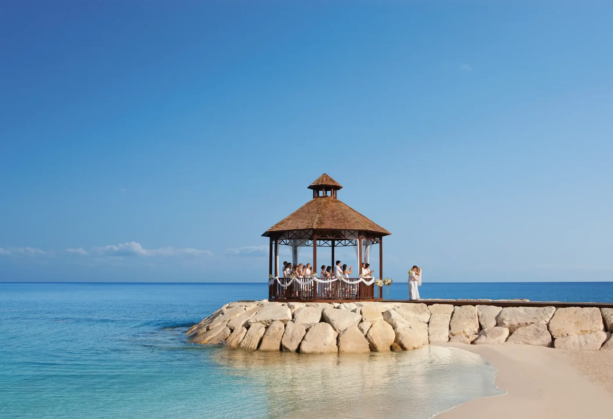 Oceanfront wedding ceremony at a gazebo on the pier at Secrets Wild Orchid, Montego Bay