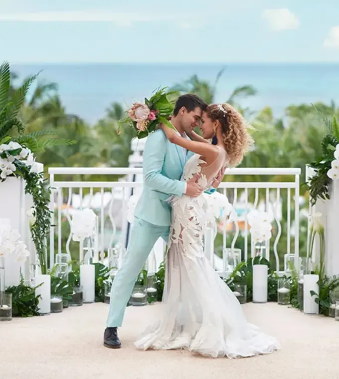 The bride and groom posing during a rooftop wedding ceremony at SLS Playa Mujeres, Cancun