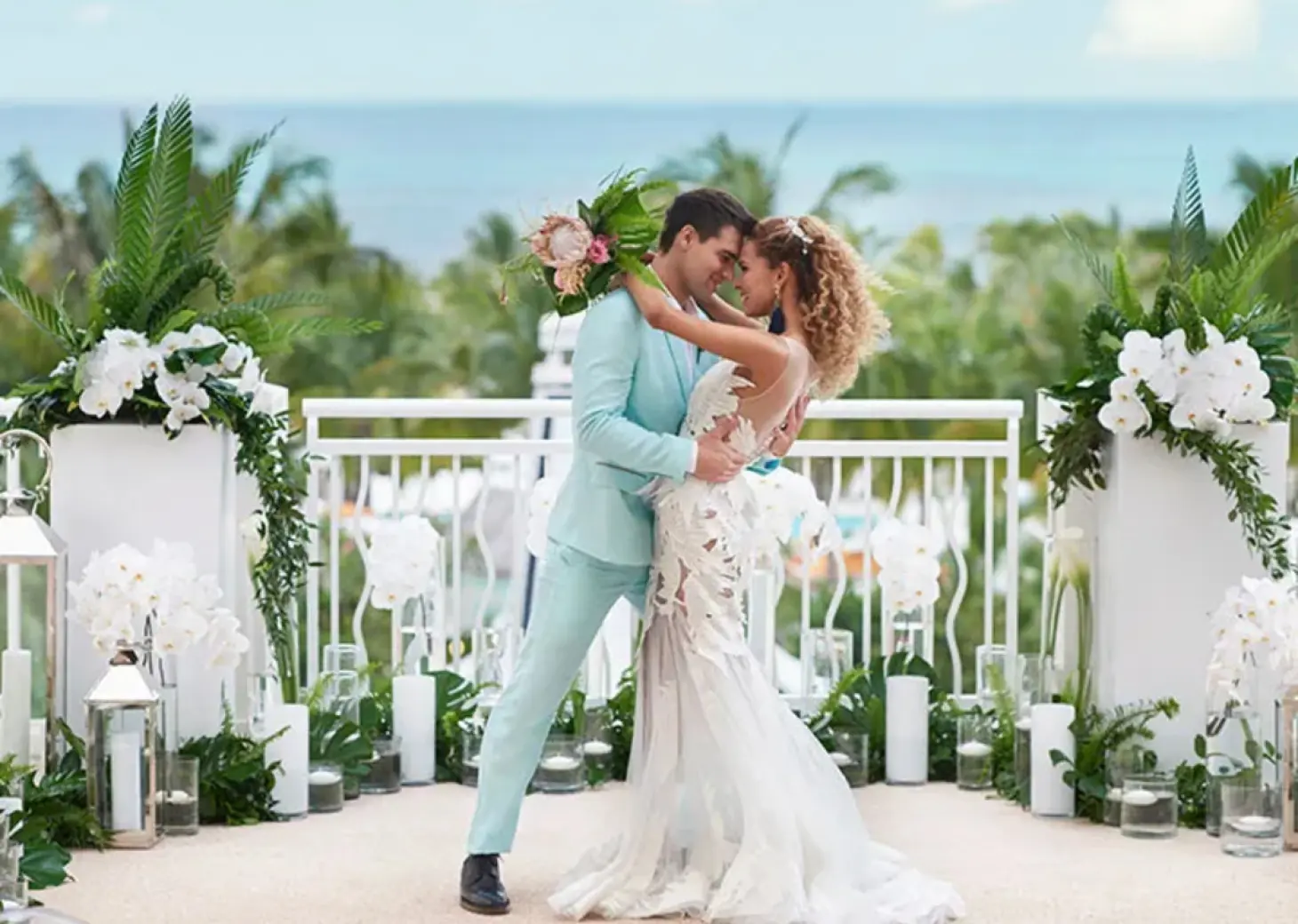 The bride and groom posing during a rooftop wedding ceremony at SLS Playa Mujeres, Cancun