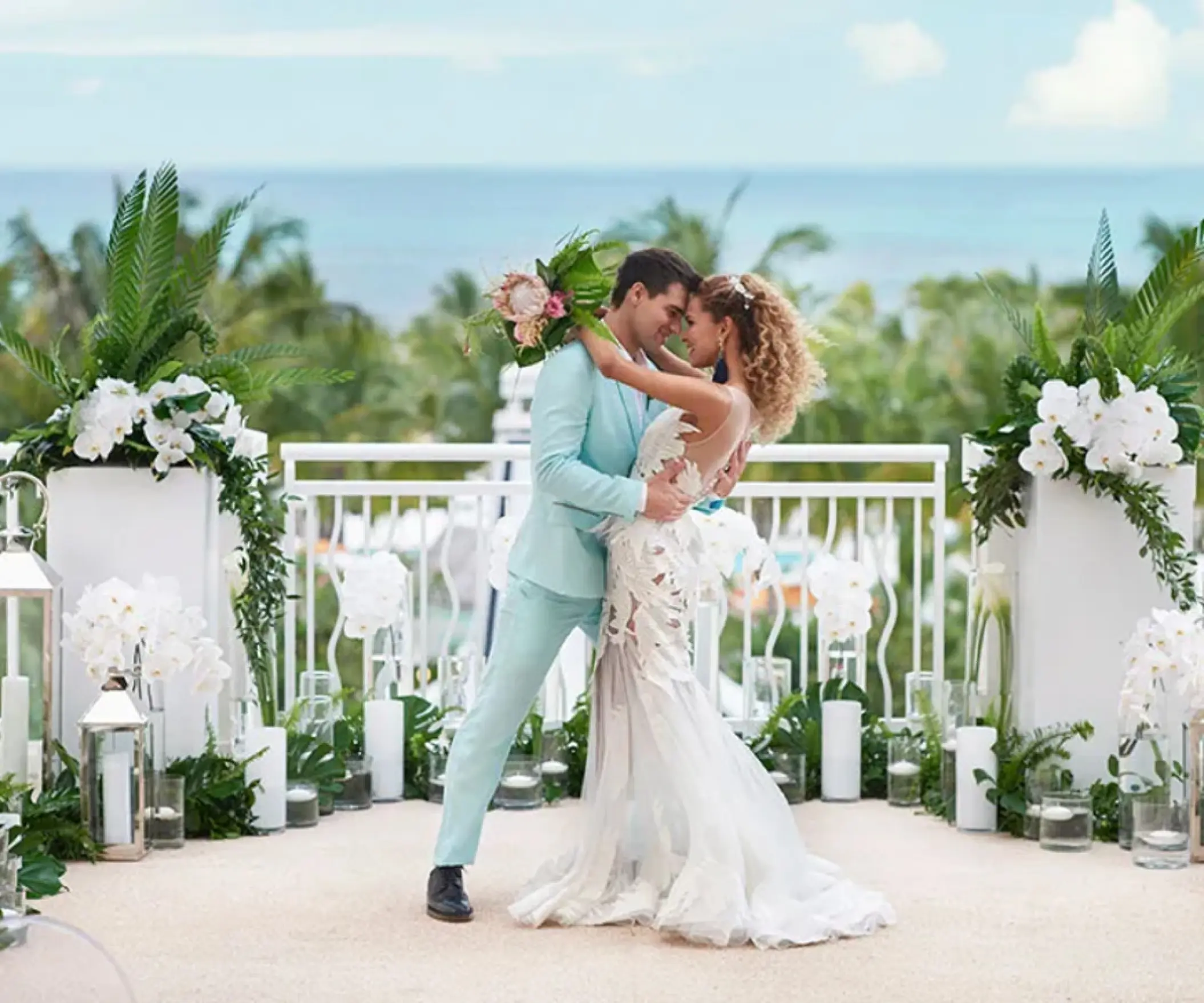 The bride and groom posing during a rooftop wedding ceremony at SLS Playa Mujeres, Cancun