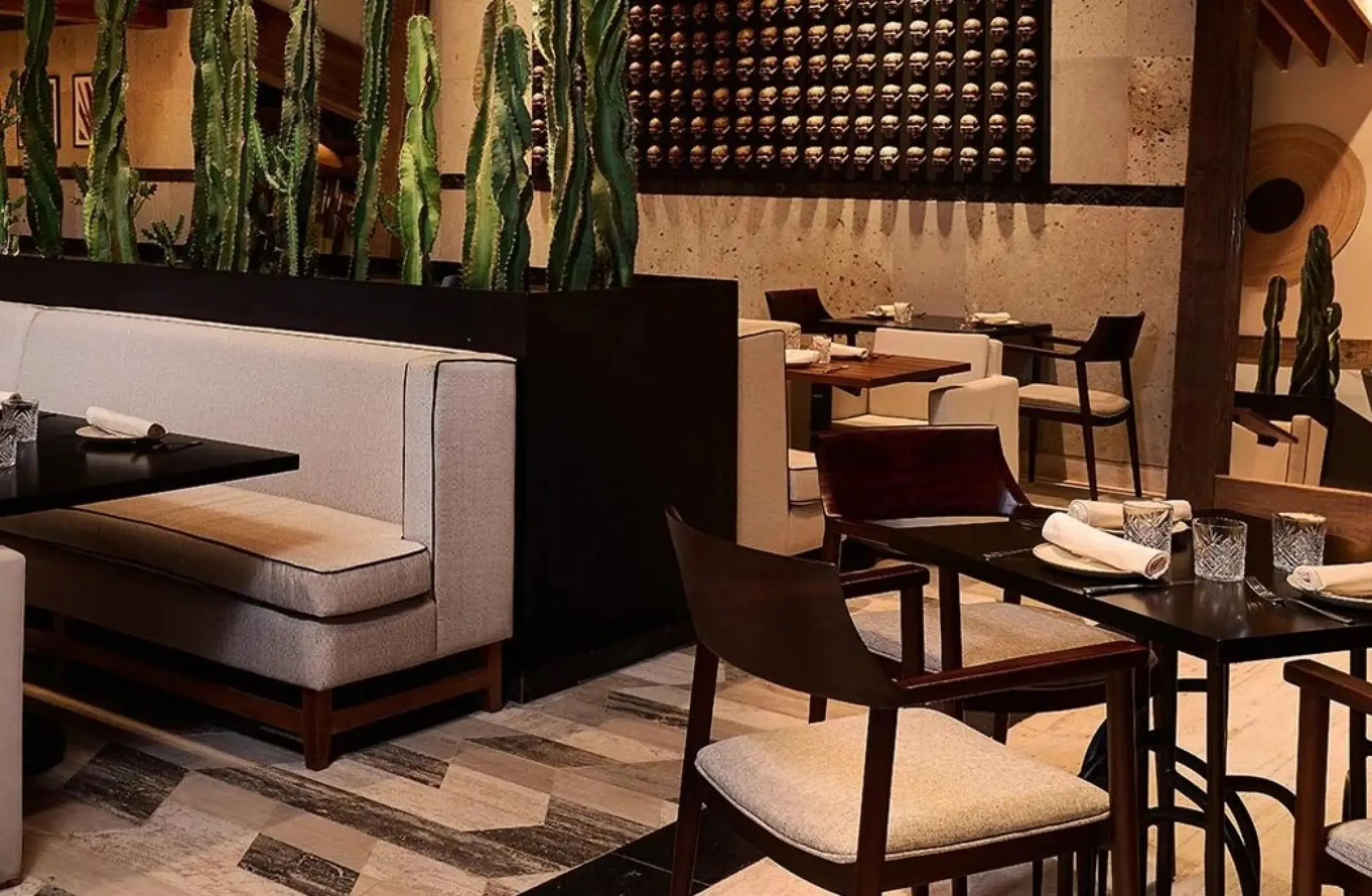 Caracol restaurant dining room with cactus decor at SLS Playa Mujeres, Cancun